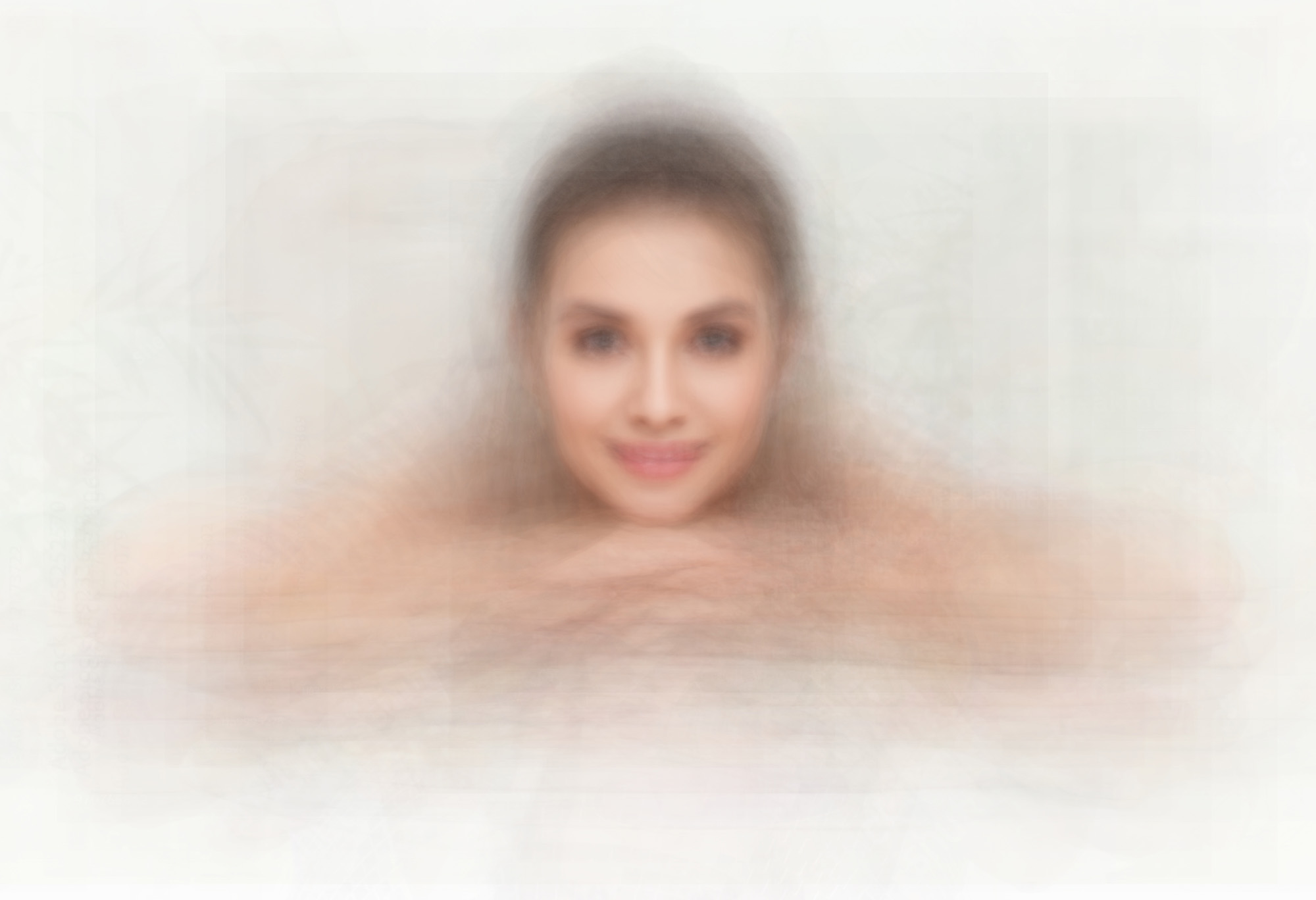 Blurry image of a white woman resting her chin on her hands. The arms are very blury.